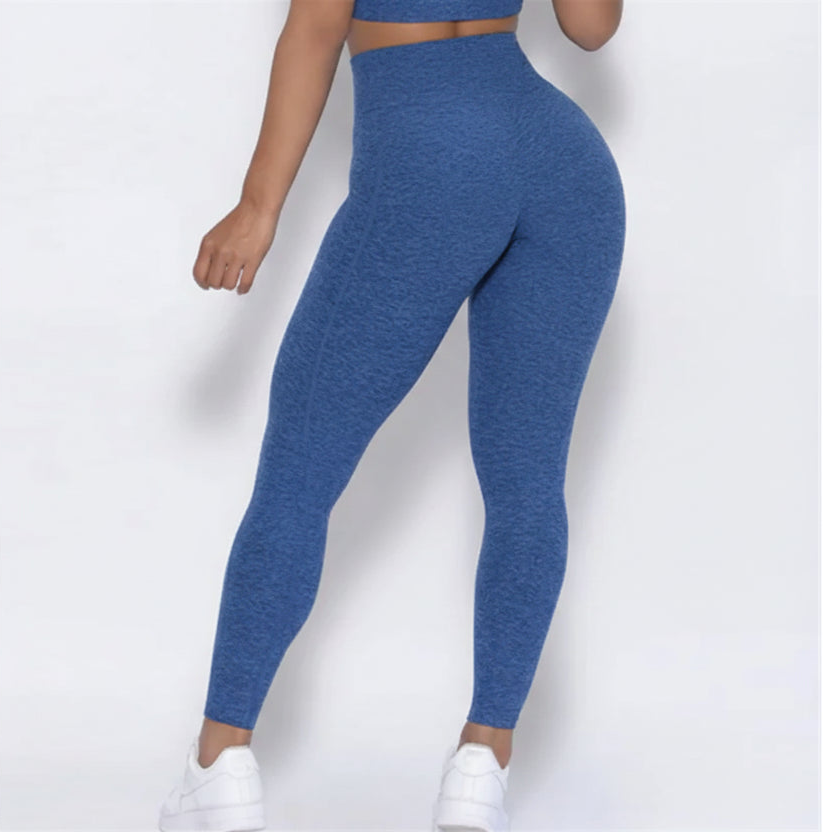 Blue leggings worn by a person on a white background